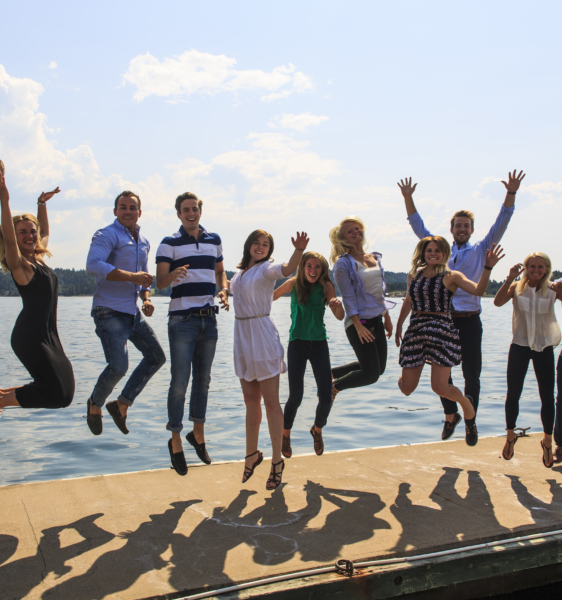 The students selected for DNV’s Summer Project celebrating the launch of the Ocean Oasis concept project jumping in the air, with the ocean in the background.